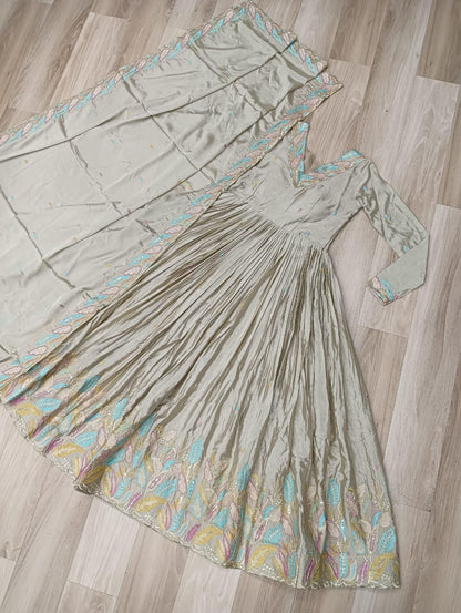 Long dress with floral embroidery on a wooden floor