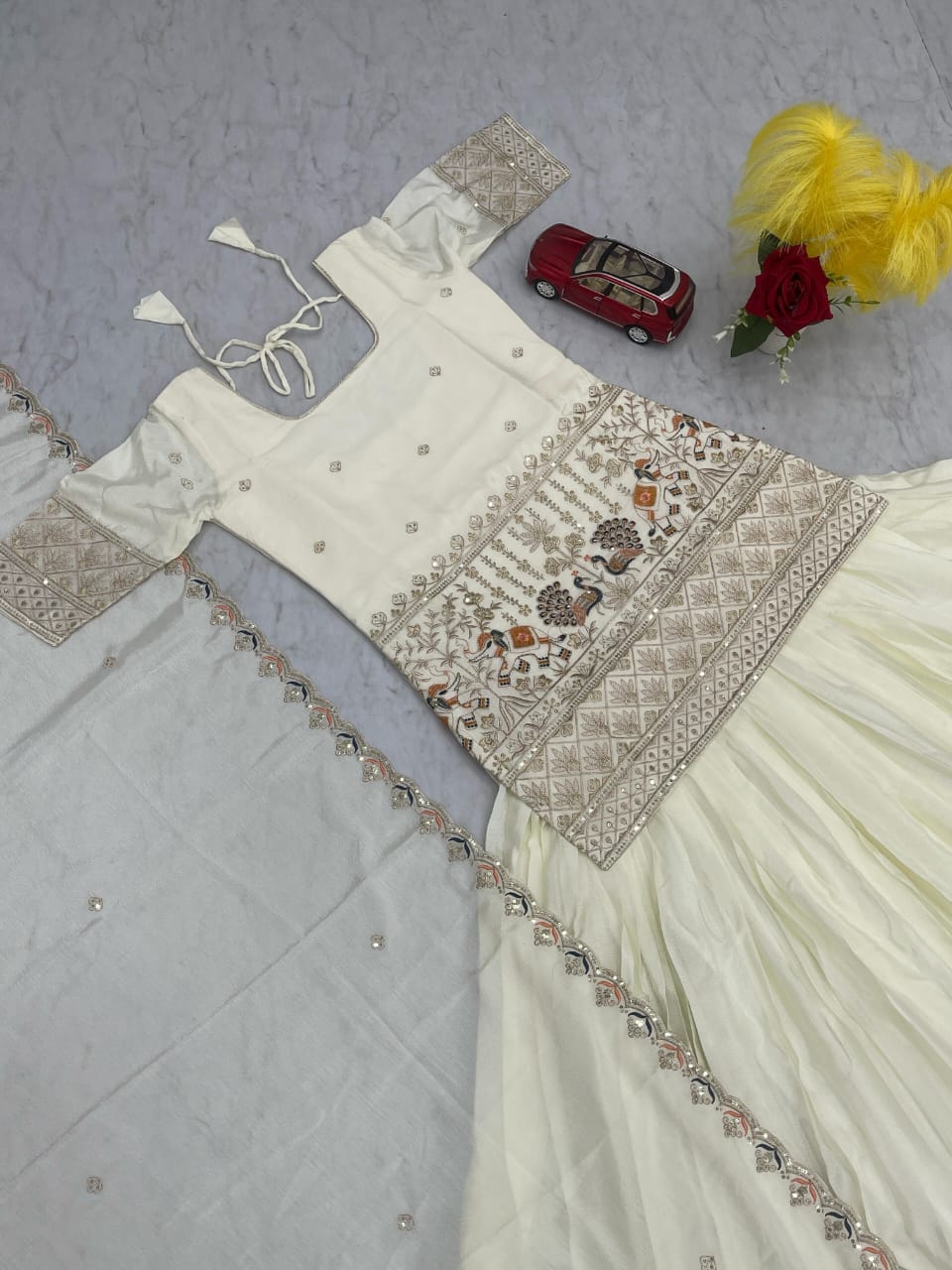 Ivory Chinon Lehenga with Peacock & Elephant Embroidery and Gold-Red Border
